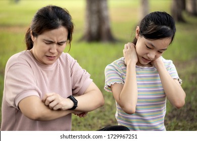 Asian Woman And Child Girl Itching Her Arm And Neck From Insect Bites,mosquito Bite,risk Of Dengue Fever,malaria,itchy,scratching With Hand Or Sensitive Skin,sweat Allergy,allergic Rash In The Garden 