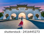 Asian woman in chinese dress traditional walking in Archway of Chiang Kai Shek Memorial Hall in Taipei, Taiwan. Translation: "Liberty Square".