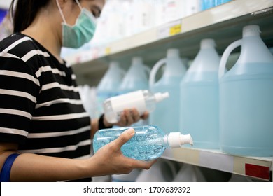 Asian Woman Is Choosing The Alcohol Antiseptic Gel In Pharmacy,reading Product Information On Label,girl Is Buying Hand Sanitizer Product For Hands Washing During The Covid-19,pandemic Of Coronavirus 