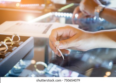 Asian Woman Choosing Wedding Rings At Jewelry Diamond Store Shop