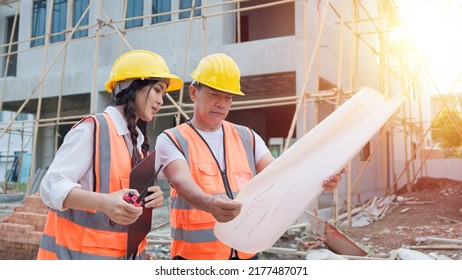 Asian Woman Civil Engineer Or Architect, Inspector With Contractor, Foreman Or Worker Wear Safety Helmet. Colleagues Discussing, Meeting About Construction Building Project On Site.