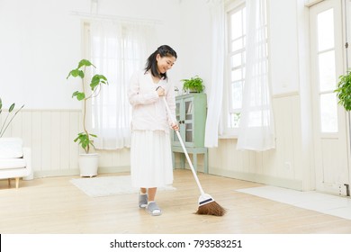 Asian Woman Cleaning The Room