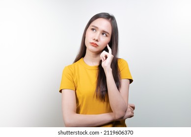 asian woman in color casual dress thinking and imagination isolated on pink background - Powered by Shutterstock