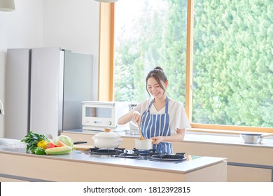 Asian Woman Cooking At Home