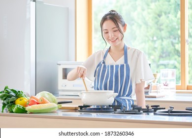 Asian Woman Cooking At Home