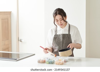 Asian Woman Cooking In The Kitchen