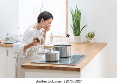 Asian Woman Cooking In The Kitchen