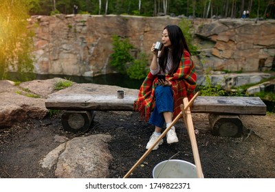 Asian Woman With A Cup And A Blanket In Camping In Autumn Forest.