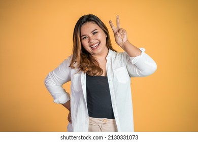 Asian Woman With Cute Hand Gesture Making V Shape On Finger