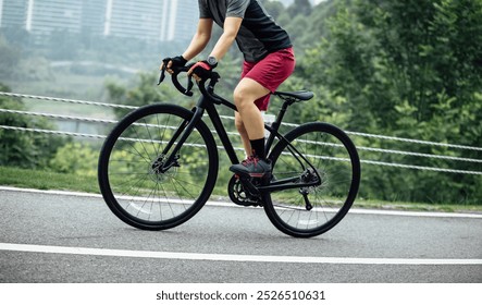 Asian woman cycling at summer park - Powered by Shutterstock