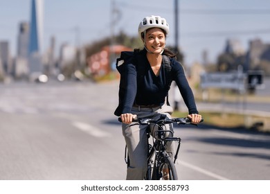 Asian woman cycling to work in the city - Powered by Shutterstock