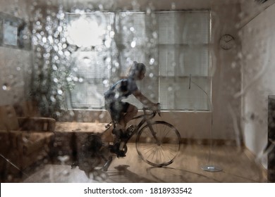 Asian woman cyclist. She is exercising in the home.By cycling on the trainer and play online bike games.During the rainy season