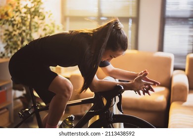 Asian woman cyclist. She is exercising in the house.By cycling on the trainer she is tired
 - Powered by Shutterstock