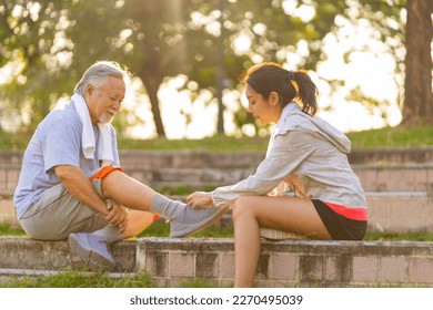 Asian woman daughter helping elderly father tie running shoe laces during jogging exercise together at park. Retired senior man health care with outdoor lifestyle sport training workout in the city. - Powered by Shutterstock