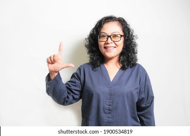 An Asian Woman Demonstrating The Letter L. Sign Language Symbol For Deaf Human With White Background. Isolated