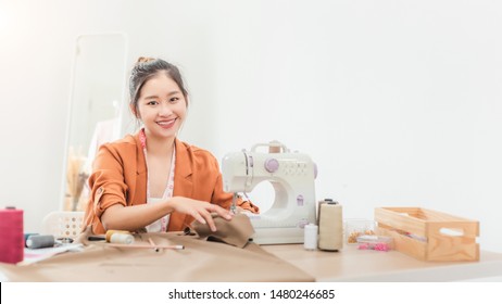 Asian Woman Designer As A Startup Business Owner In Her Tailor Shop