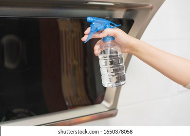 Asian Woman Disinfecting And Cleaning The Kitchen