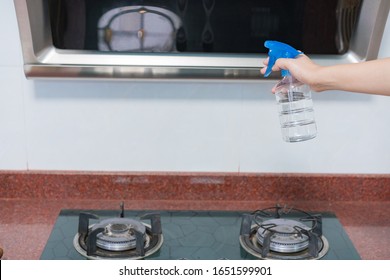 Asian Woman Disinfecting And Cleaning The Kitchen