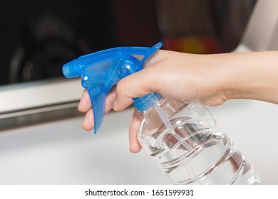 Asian Woman Disinfecting And Cleaning The Kitchen