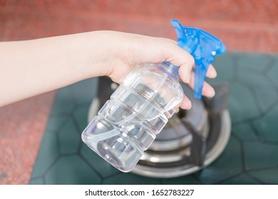 Asian Woman Disinfecting And Cleaning The Kitchen