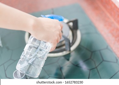 Asian Woman Disinfecting And Cleaning The Kitchen