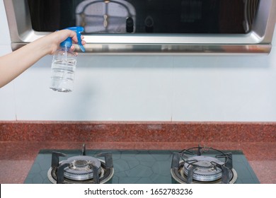 Asian Woman Disinfecting And Cleaning The Kitchen