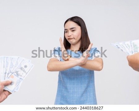 An Asian woman displays integrity, refusing to accept money offered by an unseen person, symbolizing anti-corruption and ethical behavior.