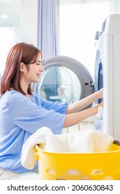 Asian Woman Do The Laundry In Smart Washing Machine At Home