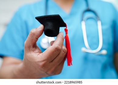 Asian Woman Doctor Holding Graduation Hat In Hospital, Medical Education Concept.