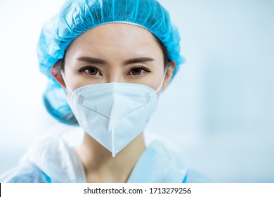 Asian Woman Doctor Look To You With Facial Mask In Hospital