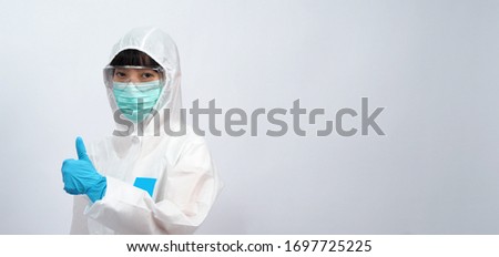 Asian woman doctor in PPE suit with hood and wearing medical mask and gloves for best protection from chemical or virus such as coronavirus or covid-19 and represent virus specialist 