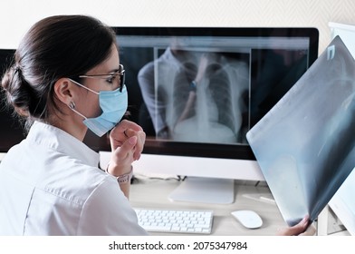 Asian Woman Doctor Radiologist Examining Film X-ray Image. Analyze A Progress Of Lung Disease. Health Care Concept, Radiology Department Of Clinic Or Hospital.