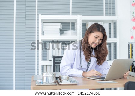 Asian woman doctor sitting in the office