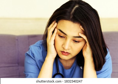 Asian Woman Doctor Stressed With Migraine Headache Overworked. Health Care Professional With Stethoscope At Hospital Feeling Unhappy, 
Tired, Disappointed, Pain, Trouble. Mixed Race Asian Chinese Model.