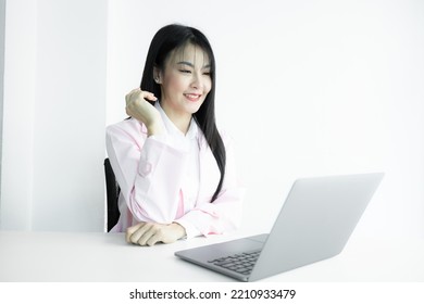 Asian woman doctor using computer laptop on white background, Asian woman doctor in pink coat with computer laptop, Medical and healthcare working diagnosing examination health. - Shutterstock ID 2210933479