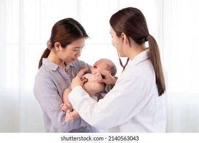 Asian woman doctor using stethoscope examining  on newborn baby in mother's arms. Mom holding adorable infant get sick crying in hospital. baby and health care concept. - Powered by Shutterstock