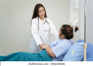 Asian Woman Doctor Visiting A Patient Who Has A Critical Health Problem About Her Weight And Unhealthy Eating Behaviour. Health Care Specialist Or Professional Physician Giving An Advise To Patient