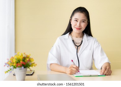 Asian Woman Doctor Woking In The Doctor Office In Hospital.