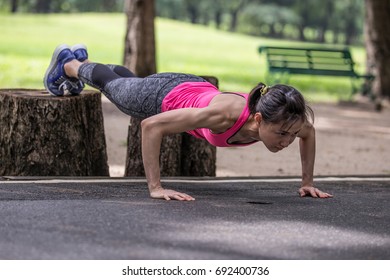 An Asian Woman Doing Decline Push Up