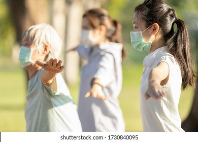 Asian Woman Is Doing Exercise Activity For The Old Elderly And Child Girl,family Workout And Wearing Medical Mask Outdoor After Coronavirus Quarantine Or Covid-19 Lockdown,healthy Senior,health Care