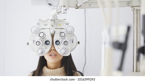 Asian Woman doing eye test in clinic 