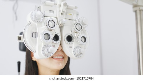 Asian Woman Doing Eye Test In Clinic 