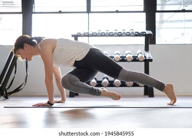 Asian Woman Doing Mountain Climber In Training Gym