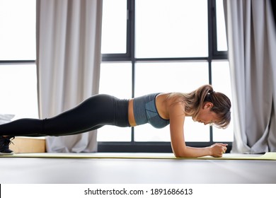 Asian Woman Doing Plank At Home, Practice Strength Of Will, Wearing Sportive Outfit