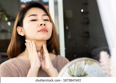 Asian Woman Doing Self Lymph Node, Checking Thyroid Gland On Her Neck