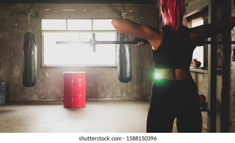 Asian Woman Doing Weight Lifting At The Gym.