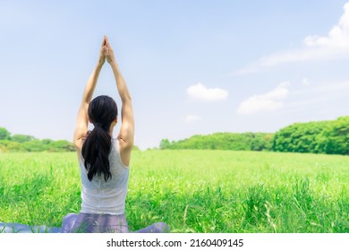 Asian Woman Doing Yoga In Green Park. Park Yoga. Mindfulness.