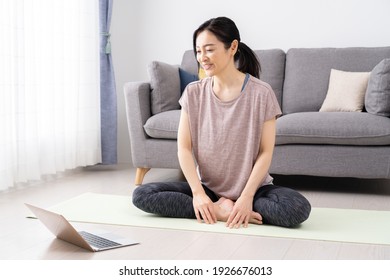 Asian Woman Doing Yoga At Home