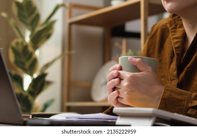 Asian Woman Drink Coffee Cup And Watching Live Streaming On Laptop When Work At Home