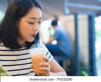 Asian Woman Drink Iced Coffee In The Cafe.